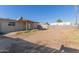 Wide backyard displaying a dirt ground cover and the back of the home at 7619 W Clarendon Ave, Phoenix, AZ 85033