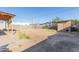 Backyard with a mix of dirt and grass, and a detached structure at the back at 7619 W Clarendon Ave, Phoenix, AZ 85033