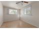 An airy bedroom with tiled floors features two windows for plenty of natural light at 7619 W Clarendon Ave, Phoenix, AZ 85033