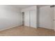 A cozy bedroom includes a closet with sliding doors and built-in shelving for efficient organization at 7619 W Clarendon Ave, Phoenix, AZ 85033