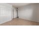 A tidy bedroom with tile flooring, a closet with sliding doors, and a view to another room at 7619 W Clarendon Ave, Phoenix, AZ 85033