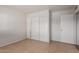This bedroom features tile floors and a closet with sliding doors, offering practical storage solutions at 7619 W Clarendon Ave, Phoenix, AZ 85033