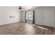 Spacious living room featuring stylish wood-look flooring and large windows at 7619 W Clarendon Ave, Phoenix, AZ 85033