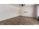 Bright, empty living room featuring modern wood-look floors and ceiling fan at 7619 W Clarendon Ave, Phoenix, AZ 85033