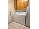 Functional laundry room with washer, dryer, and overhead cabinet storage at 8161 E Keats Ave # 376, Mesa, AZ 85209