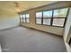 Bright sun room with multiple windows offering backyard views, ceiling fan, and an exit door at 8161 E Keats Ave # 376, Mesa, AZ 85209