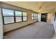 Enclosed sun room filled with natural light from numerous windows, ceiling fan, and neutral carpeting at 8161 E Keats Ave # 376, Mesa, AZ 85209