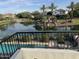Beautiful backyard view with a lake, lush greenery, and palm trees at 861 E Canyon Way, Chandler, AZ 85249