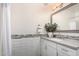 Bathroom vanity with framed mirror, white cabinets, neutral paint, and a decorative backsplash at 861 E Canyon Way, Chandler, AZ 85249