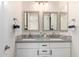 Bathroom featuring dual sinks with white cabinets and marble countertops and framed mirrors at 861 E Canyon Way, Chandler, AZ 85249