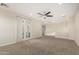Large bonus room with carpet flooring, ceiling fan, and a sliding glass door at 861 E Canyon Way, Chandler, AZ 85249