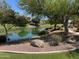 Scenic community lake view with mature trees, landscaping, and neighborhood homes at 861 E Canyon Way, Chandler, AZ 85249