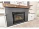 Close-up of a modern fireplace with a rustic wood mantel and built-in shelving at 861 E Canyon Way, Chandler, AZ 85249