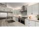 Modern kitchen featuring stainless steel appliances, white cabinets and stone countertops at 861 E Canyon Way, Chandler, AZ 85249
