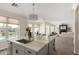 Open kitchen with island seating, a view of the living room, and abundant natural light at 861 E Canyon Way, Chandler, AZ 85249