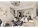 Bright living room with modern decor, featuring a chandelier and a staircase in the background at 861 E Canyon Way, Chandler, AZ 85249