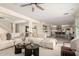Open-concept living room with a large sectional sofa and views of the kitchen and dining area at 861 E Canyon Way, Chandler, AZ 85249