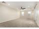 Spacious living room with neutral walls, carpet flooring, ceiling fan, and a glass door at 861 E Canyon Way, Chandler, AZ 85249