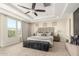 Main bedroom featuring a tray ceiling, carpet flooring, ceiling fan and outside view at 861 E Canyon Way, Chandler, AZ 85249