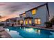 Back exterior of home featuring a backyard pool, grill, and covered patio at dusk at 861 E Canyon Way, Chandler, AZ 85249