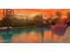 Backyard swimming pool with a basketball hoop and patio furniture at sunset at 861 E Canyon Way, Chandler, AZ 85249