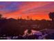 Stunning sunset view over a lake with silhouettes of trees and houses at 861 E Canyon Way, Chandler, AZ 85249