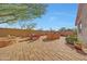 Spacious backyard features a stone outdoor kitchen and covered area with seating at 8687 W Bajada Rd, Peoria, AZ 85383
