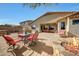 Spacious backyard with outdoor dining, a stone fireplace, outdoor barbeque and desert landscaping at 8687 W Bajada Rd, Peoria, AZ 85383