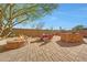 The backyard features an outdoor stone fire pit, seating area, outdoor kitchen and dining at 8687 W Bajada Rd, Peoria, AZ 85383