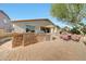 Backyard featuring a stone outdoor kitchen with barbecue and covered dining with seating area at 8687 W Bajada Rd, Peoria, AZ 85383