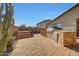 The backyard offers an outdoor kitchen with a barbecue and stone fire pit with room to entertain at 8687 W Bajada Rd, Peoria, AZ 85383