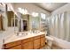 Bright bathroom featuring double sinks with a shower tub combination and a large mirror at 8687 W Bajada Rd, Peoria, AZ 85383