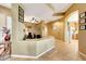 Hallway with an arched entryway, built-in half wall, and decorative touches throughout at 8687 W Bajada Rd, Peoria, AZ 85383