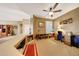 Landing area with custom built-ins, shelving, and a desk with a ceiling fan above at 8687 W Bajada Rd, Peoria, AZ 85383