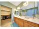 Bathroom featuring dual sinks, ample counter space, and a walk-in closet for added convenience at 8687 W Bajada Rd, Peoria, AZ 85383