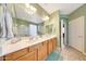 Bright bathroom featuring dual sinks, a walk-in shower, and a separate toilet room at 8687 W Bajada Rd, Peoria, AZ 85383