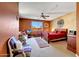 Bright primary bedroom with a ceiling fan, slider door, and a seating area for relaxation at 8687 W Bajada Rd, Peoria, AZ 85383
