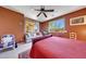 Spacious primary bedroom featuring a ceiling fan, and a cozy seating area overlooking the backyard at 8687 W Bajada Rd, Peoria, AZ 85383