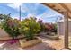 Paver patio and blooming flowers define the outdoor space in this well-maintained backyard at 940 S Revere --, Mesa, AZ 85210