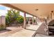 A covered patio has an outdoor kitchen & BBQ, ideal for entertaining in the landscaped yard at 940 S Revere --, Mesa, AZ 85210