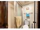 A compact bathroom with a toilet, towel rack, shower, and tan tiling at 940 S Revere --, Mesa, AZ 85210