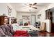 A bedroom with a dark wood floor and filled with furniture and personal items at 940 S Revere --, Mesa, AZ 85210