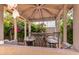 A beautiful gazebo has a wrought iron table and chairs surrounded by colorful flowers at 940 S Revere --, Mesa, AZ 85210