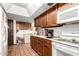 Functional kitchen with wood cabinets, neutral countertops, and appliances at 940 S Revere --, Mesa, AZ 85210