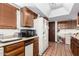 Functional kitchen with wood cabinets, neutral countertops, and appliances at 940 S Revere --, Mesa, AZ 85210