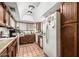 Functional kitchen with wood cabinets, neutral countertops, and appliances at 940 S Revere --, Mesa, AZ 85210