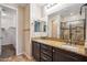 Bathroom with granite countertops, double sinks, and tiled shower with glass door at 9921 E Acceleration Dr, Mesa, AZ 85212