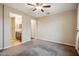 Neutral bedroom with ceiling fan and view of en suite bathroom at 9921 E Acceleration Dr, Mesa, AZ 85212