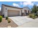 Exterior showcasing the well-manicured front yard, long driveway, and two-car garage at 9921 E Acceleration Dr, Mesa, AZ 85212