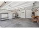 Clean garage featuring overhead storage and ample room for vehicles or recreational equipment at 9921 E Acceleration Dr, Mesa, AZ 85212